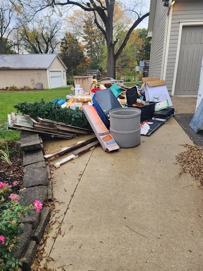 Dumpster being loaded with debris for Commercial Dumpster Rental in Forest Hills
